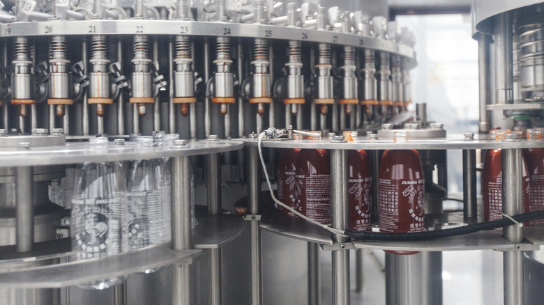 factory machines producing Sriracha