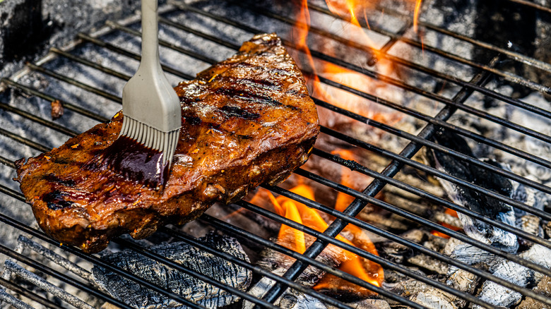basting ribs on grill with brush