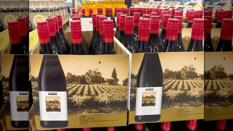 Boxes of red wine sit on a pallet in a Costco