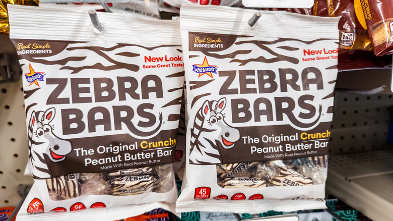 Bags of Atkinson Peanut Butter Bars hang in a grocery store aisle