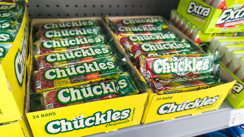 Display boxes filled with Chuckles candy sit on store shelves