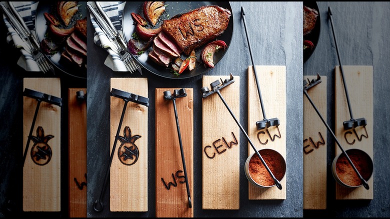 The Monogrammed Forged Steak Brand on steak and a few wood pieces