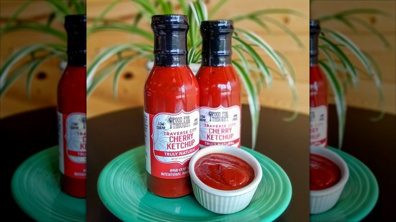 Two bottles of cherry ketchup on a plate