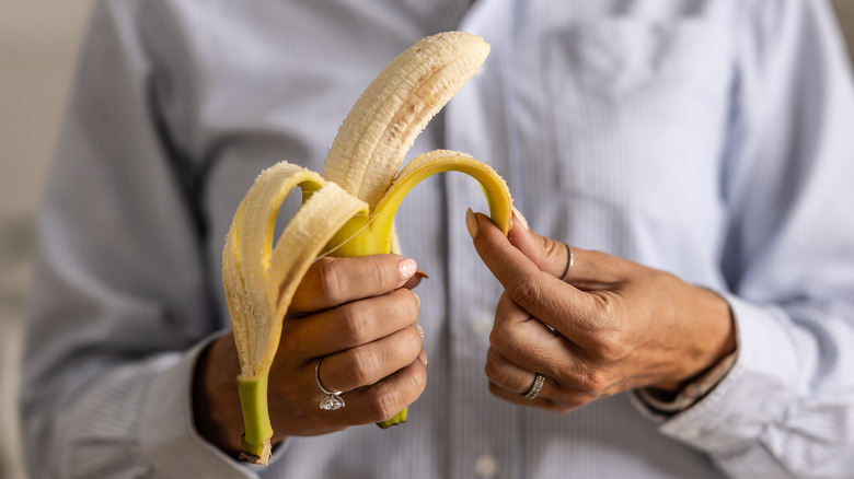 person peeling a banana