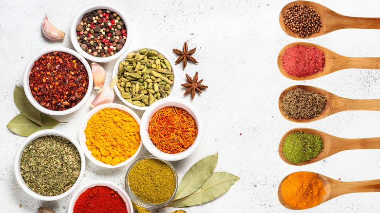 bowls and spoons of herbs and spices