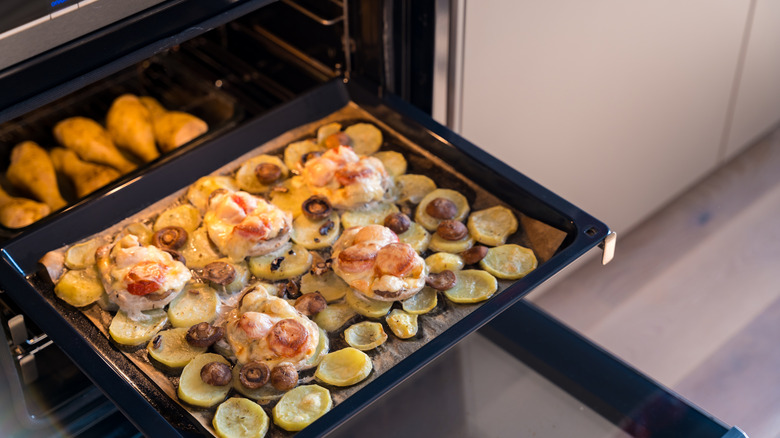 Baking tray going into an oven