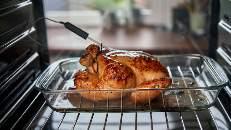 Roasting chicken in the oven with digital thermometer
