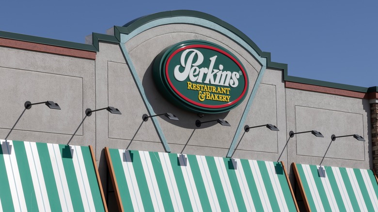 Perkins exterior including green and white striped awnings