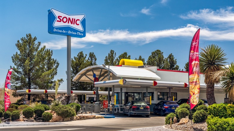 Sonic drive-in with cars parked for orders on a mildly cloudy day