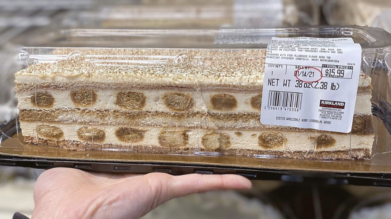 hand holding Costco tiramisu cake