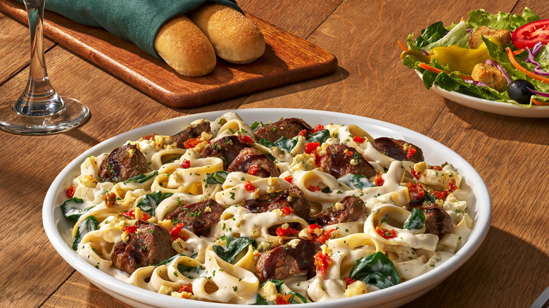 Steak on a bed of Alfredo pasta