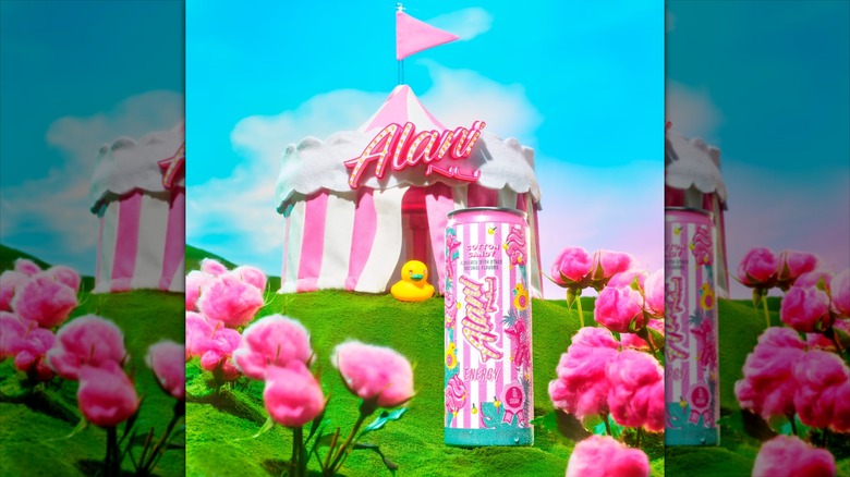 Alani Nu Energy Cotton Candy can with a vibrant outdoor background