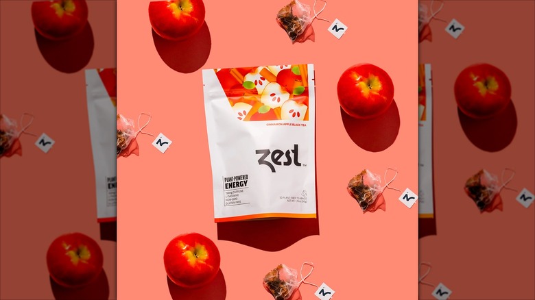Zest Cinnamon Apple Black Tea on a peach background with apples