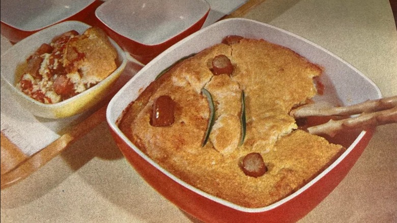 A frankfurter shortbread casserole in a red pyrex cooking dish.