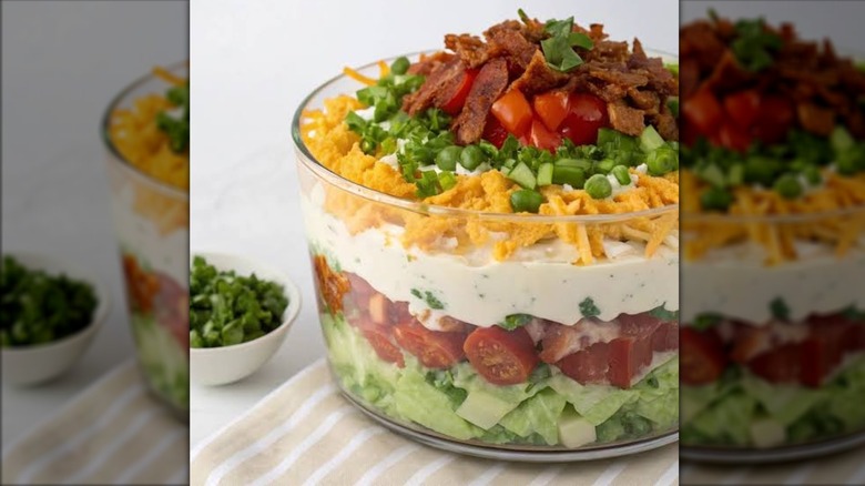 Seven-layer salad in a glass bowl.