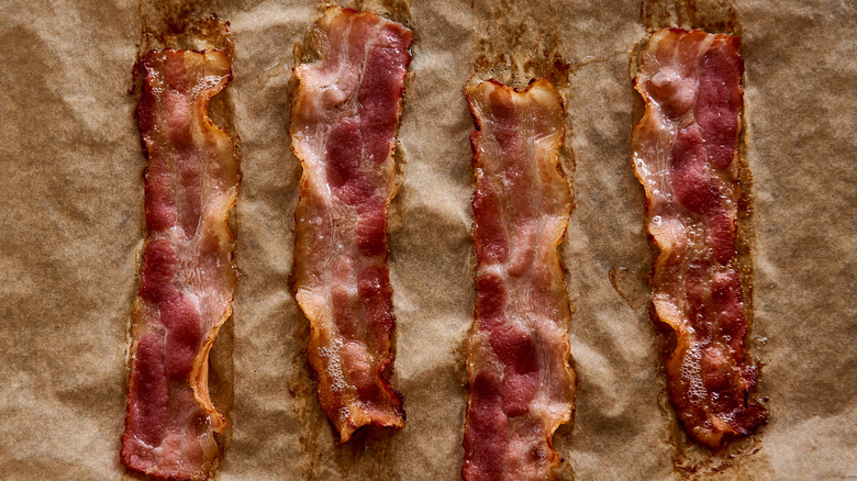 Oven baked bacon on parchment paper