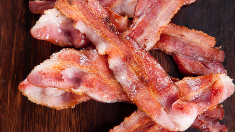 Cooked center-cut bacon on wooden board