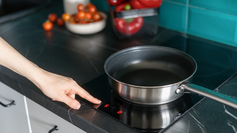 Home cook turning on stove