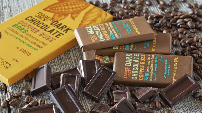trader joe's dark chocolate coffee buzz bar packages next to pieces of chocolate and coffee beans