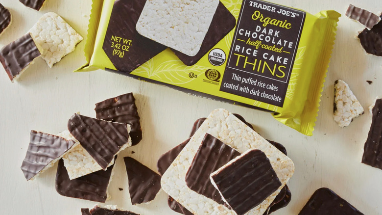 package of Trader Joe's dark chocolate rice cake thins surrounded by pieces rice cakes and chocolate