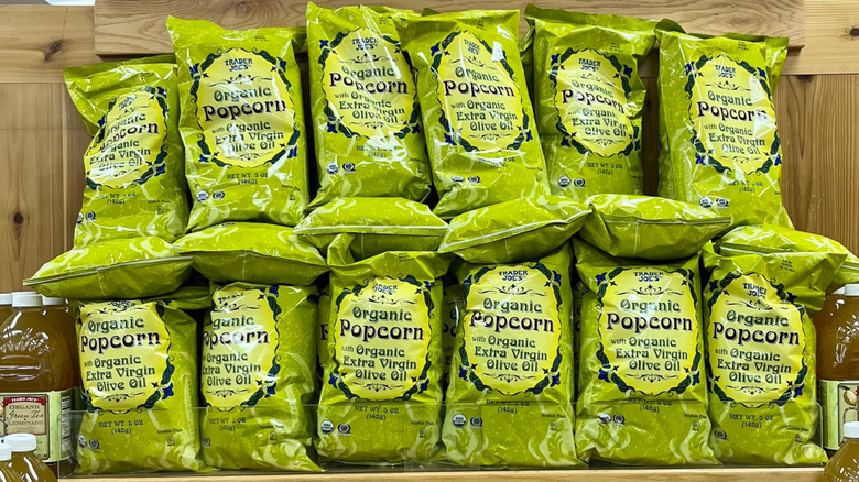 several bags of Trader Joe's olive oil popcorn on a display shelf