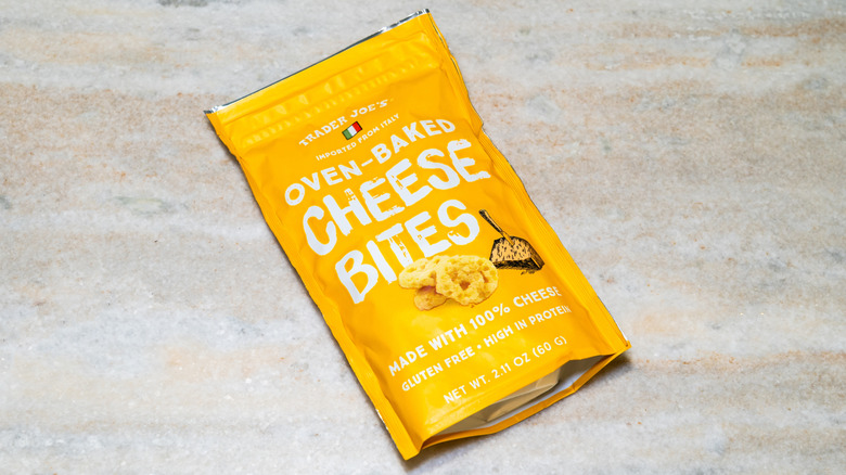 a bag of Trader Joe's oven baked cheese bites laying on a wooden floor