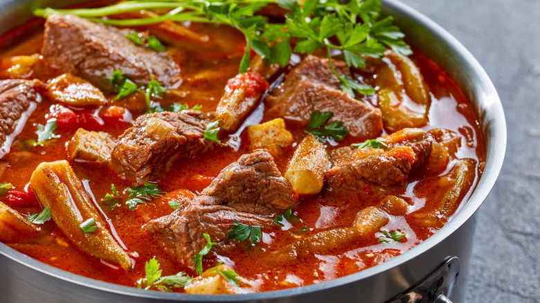 Okra stew with beef in metal pot