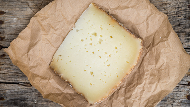 slice of pecorino on brown paper