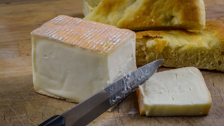 sliced Taleggio on wooden board
