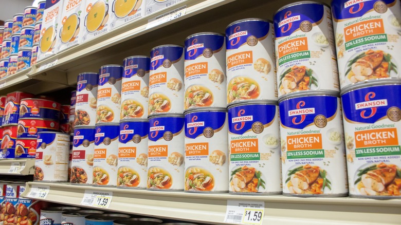 Grocery shelves of chicken broth
