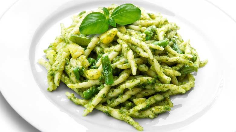 White plate of trofie al pesto Genovese pasta, potato, and green beans with basil pesto