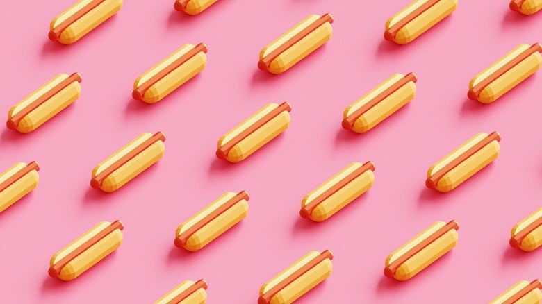 Repeating pattern of plain hot dogs with pink background