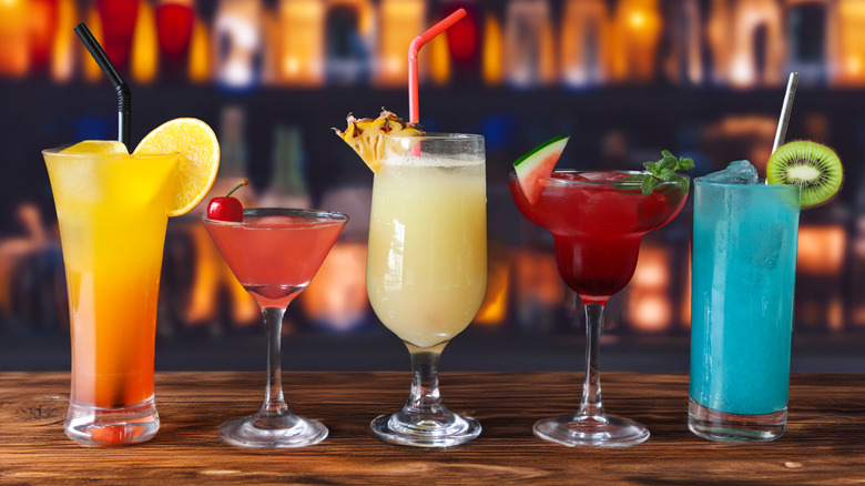 Various cocktail glasses on a bar countertop.