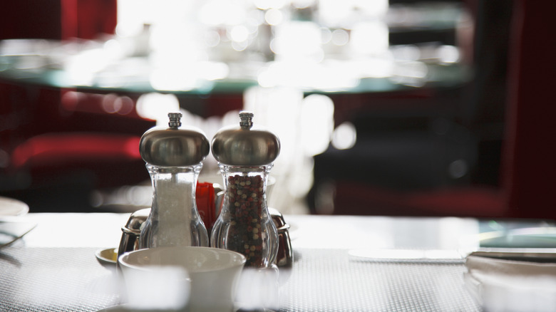 Fancy salt and pepper shakers at a restaurant.