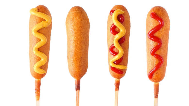 Corn dogs aligned with and without ketchup and mustard