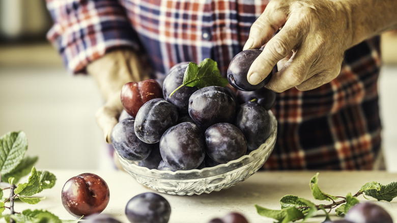 Fresh plums in a bowl