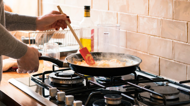 A woman stirring scrambled eggs