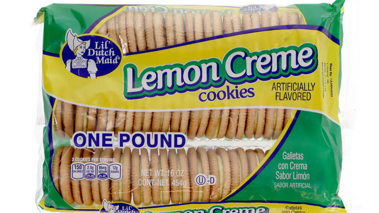 stacks of lemon creme sandwich cookies next to half a lemon