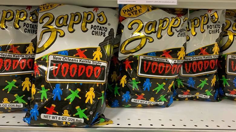 several bags of zapp's voodoo kettle chips on a store shelf