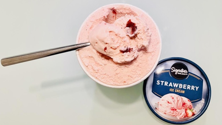 Opened pint of Signature Select Strawberry Ice Cream with spoon