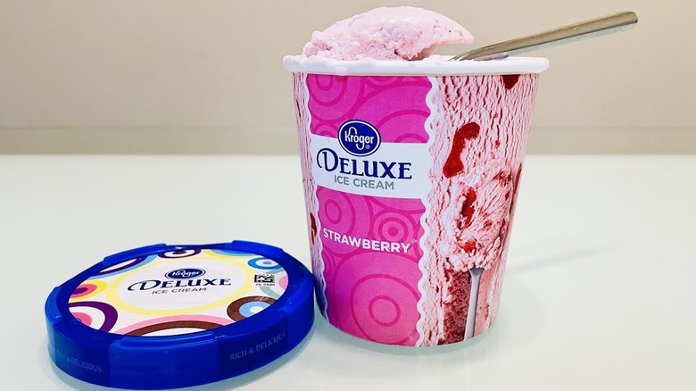 Opened pint of Kroger Deluxe Strawberry Ice Cream with spoon