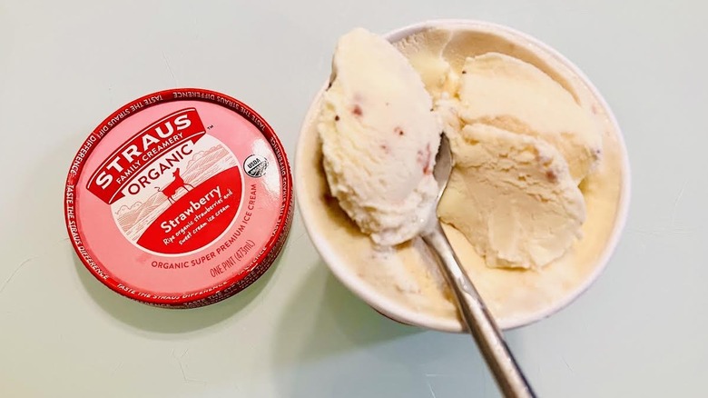 Open pint of Straus Family Creamery Organic Strawberry Ice Cream with spoon