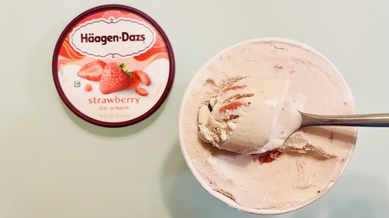 Open pint of Häagen-Dazs Strawberry Ice Cream with spoon