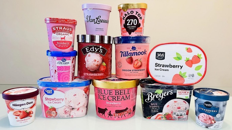 Stacked cartons of various strawberry ice cream brands