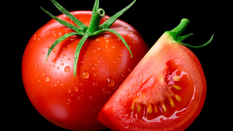 red tomato on black background
