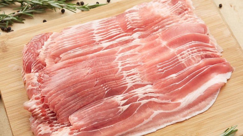 Slices of bacon on board