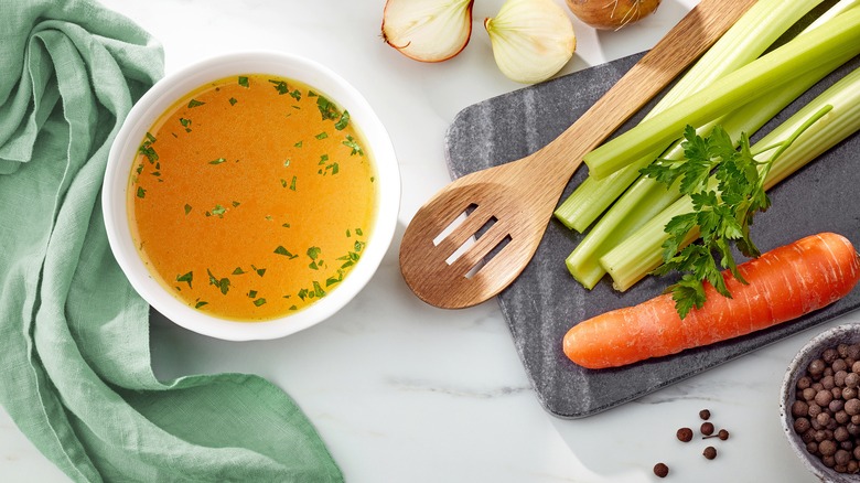 Homemade chicken stock in white bowl