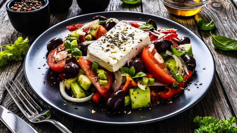 Greek salad on black plate