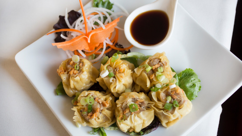 spoonful of soy sauce over dumplings