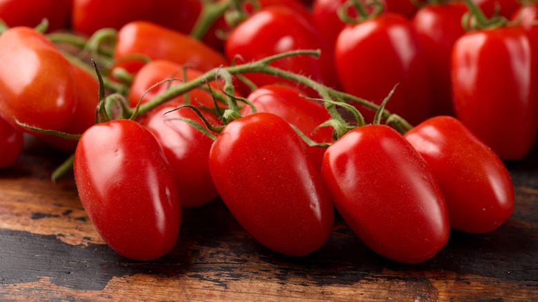 Vine of San Marzano tomatoes on wooden table